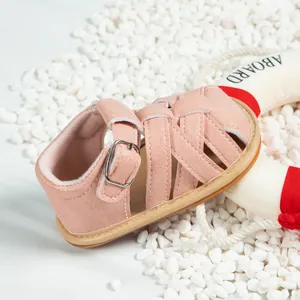 Close-up of pink toddler sandals with cross-braided straps and non-slip rubber soles