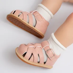 Close-up of pink baby sandals featuring woven straps and honeycomb anti-slip sole design
