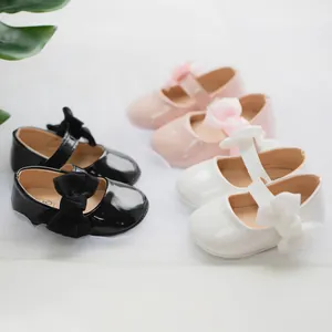 Vista dettagliata delle scarpe Mary Jane per neonati in nero, rosa e bianco con finitura lucida