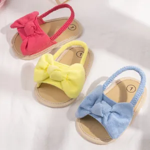 Infant bow-knot walking sandals in rose red, yellow, and blue with elastic straps