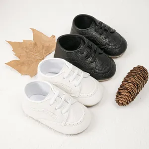 Detailed macro view of litchi texture leather baby walking shoes with lace-up design
