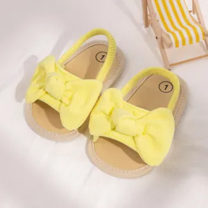 Yellow baby sandals with soft bow and elastic heel strap for infants 0-1 year