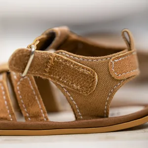 Close-up of brown baby sandals showing durable canvas fabric and adjustable velcro straps