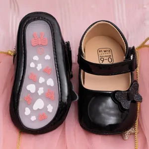 Detail of baby princess shoes showing non-slip rubber sole with hearts and velcro strap