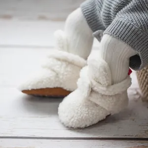 Plush white sherpa baby boots with warm soft soles for infant winter indoor walking
