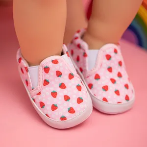 Detail of pink baby canvas loafer with strawberry pattern and elastic side band