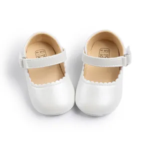 White faux leather baby Mary Jane shoes with scalloped trim and non-slip rubber soles