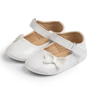White faux leather baby Mary Jane shoes with shiny bow detail and velcro strap