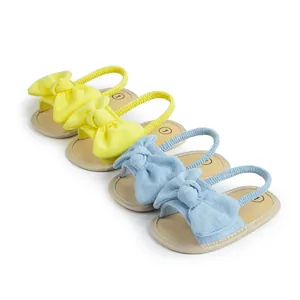 Infant soft sole summer sandals in yellow and light blue with decorative bow details