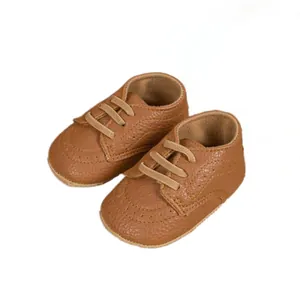 Classic British style baby walker shoes in brown leather with elegant brogue perforation
