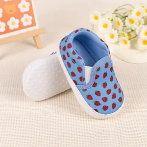 Detail of baby canvas loafers with red strawberry patterns and non-slip soft soles