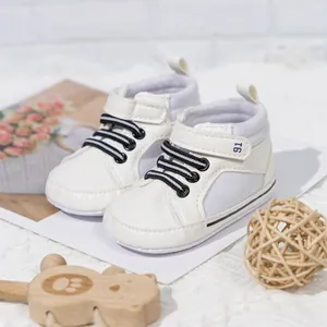 Detail of white high-top baby walking shoes with velcro strap and striped elastic laces