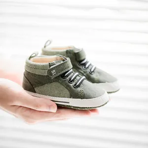 Detail view of military green high-top crib shoes with velcro strap and soft sport soles