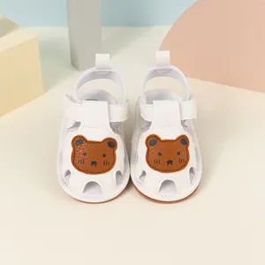 White baby sandals with cartoon bear patch and soft non-slip soles for toddlers