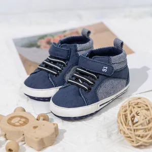 Detail of baby shoes with Velcro strap featuring number 16 and non-slip soft white sole