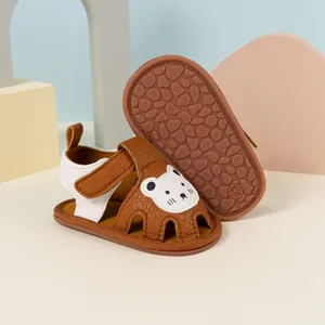 Detail of baby summer sandals featuring a cute white bear patch and non-slip rubber sole