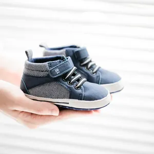 Detail of blue high-top baby walker shoes with PU leather and velcro straps showing the 91 logo