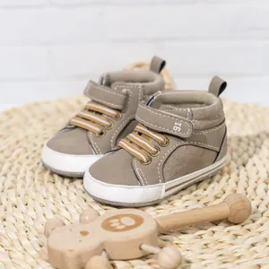 Close-up of baby high-top walker shoes with hook and loop closure and decorative laces