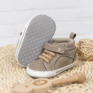 Close-up of brown high-top baby shoes with velcro straps and anti-slip rubber soles