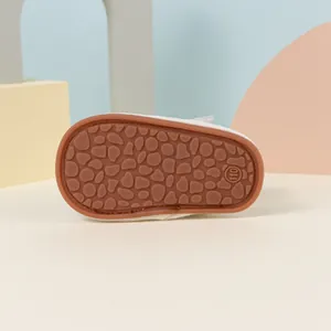 Detailed view of non-slip rubber sole with pebble texture on baby walking shoes