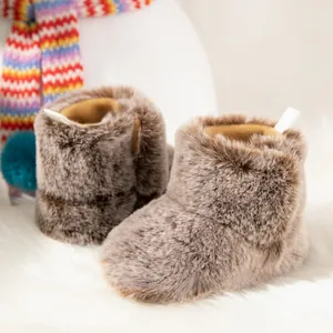 Detail of warm khaki faux fur baby boots with plush lining and heel pull tab for winter