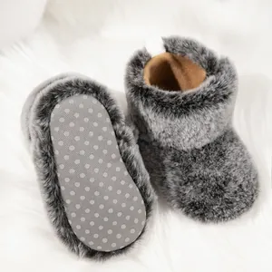 Detailed view of the plush baby bootie featuring a non-slip dotted sole and warm fleece lining