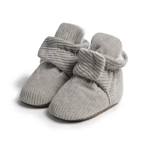 Vue détaillée de chaussons bébé en velours côtelé gris avec doublure polaire blanche