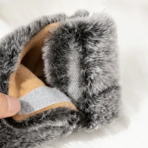 Detail of baby winter boot featuring grey faux fur exterior and warm fleece lining