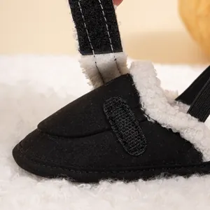 Macro detail of baby shoes showing black fabric, warm fleece lining, and velcro strap