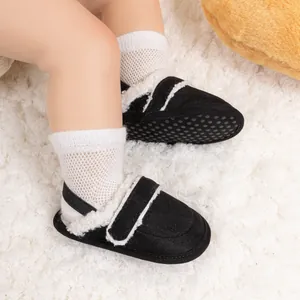 Detail of warm baby walking shoes with plush lining and non-slip soles on a soft rug