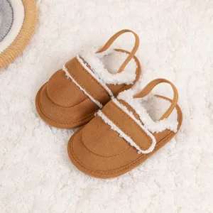 Close-up of warm brown baby slippers with soft fleece lining and elastic back strap