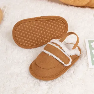 Close-up of warm baby shoes with plush lining and non-slip dotted soles in brown