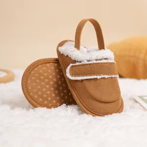 Detail of warm baby winter shoes with brown canvas, faux fur trim and non-slip soles