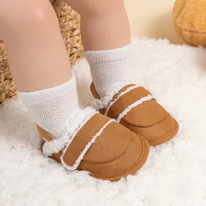 Close-up of brown baby walking shoes with white plush trim and velcro strap closure
