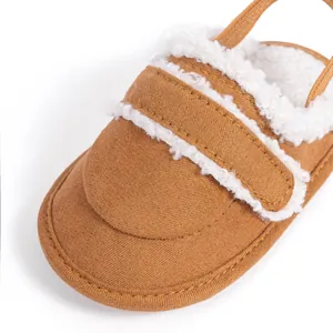Detail of warm brown baby shoes with soft white fleece lining and fine stitching