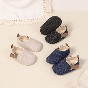 Flat lay of breathable baby walker shoes in beige, dark blue, and black with anti-slip soles