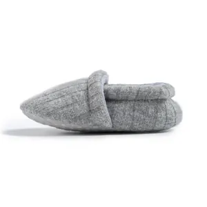 Detail of grey knitted baby shoe with anti-slip sole and soft ribbed texture fabric