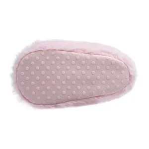 Detail showing non-slip dotted sole of baby plush boots with warm pink faux fur