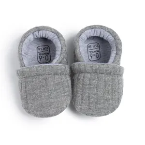 Detailed view of gray knit baby shoes showing the size label for 0-6 months infants