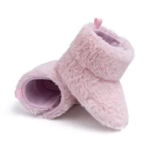 Detail of plush pink baby winter boots with fluffy texture and easy-pull heel tab