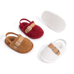 Close-up of plush baby shoes featuring fleece texture and anti-slip dotted soles