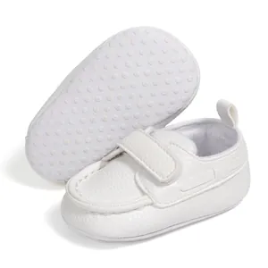 Detailed view of white baby walking shoes with anti-slip dotted soft fabric sole