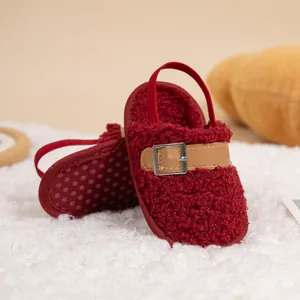 Detail of warm burgundy baby fleece shoes with plush texture and elastic heel strap