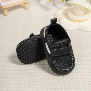 Close-up of baby walking shoes with non-slip dotted soles and velcro closure