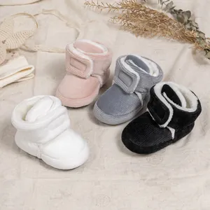 Detail of four colorful velvet baby boots with warm plush lining and velcro straps