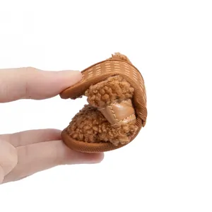 Detail showing the ultra-flexible and soft brown plush baby shoes for winter