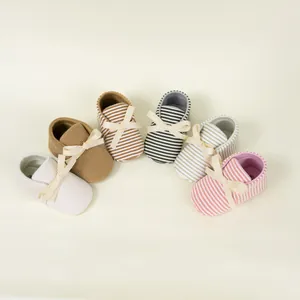 Detailed collection of striped baby shoes with cute satin bows in various soft colors