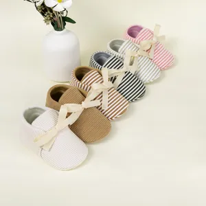 Detail showing various striped baby shoes with silk bows and elastic soft soles