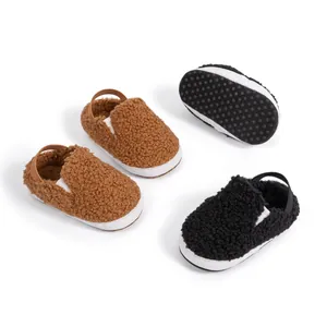 Close-up of warm sherpa baby slippers with non-slip dots and soft fleece texture