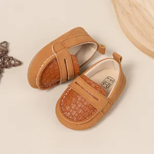 Detail of brown baby loafer showing the size 18 and 0-6 months age label inside the shoe